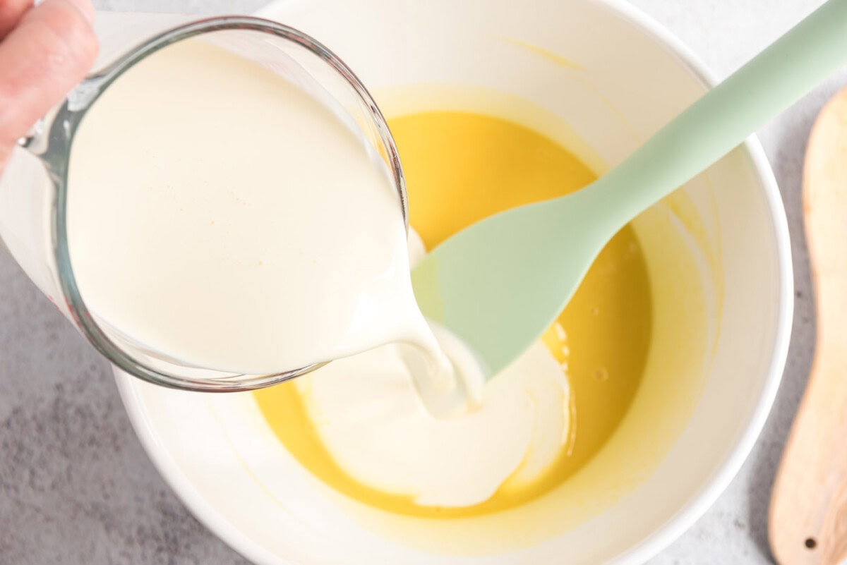 Cream being poured into the custard