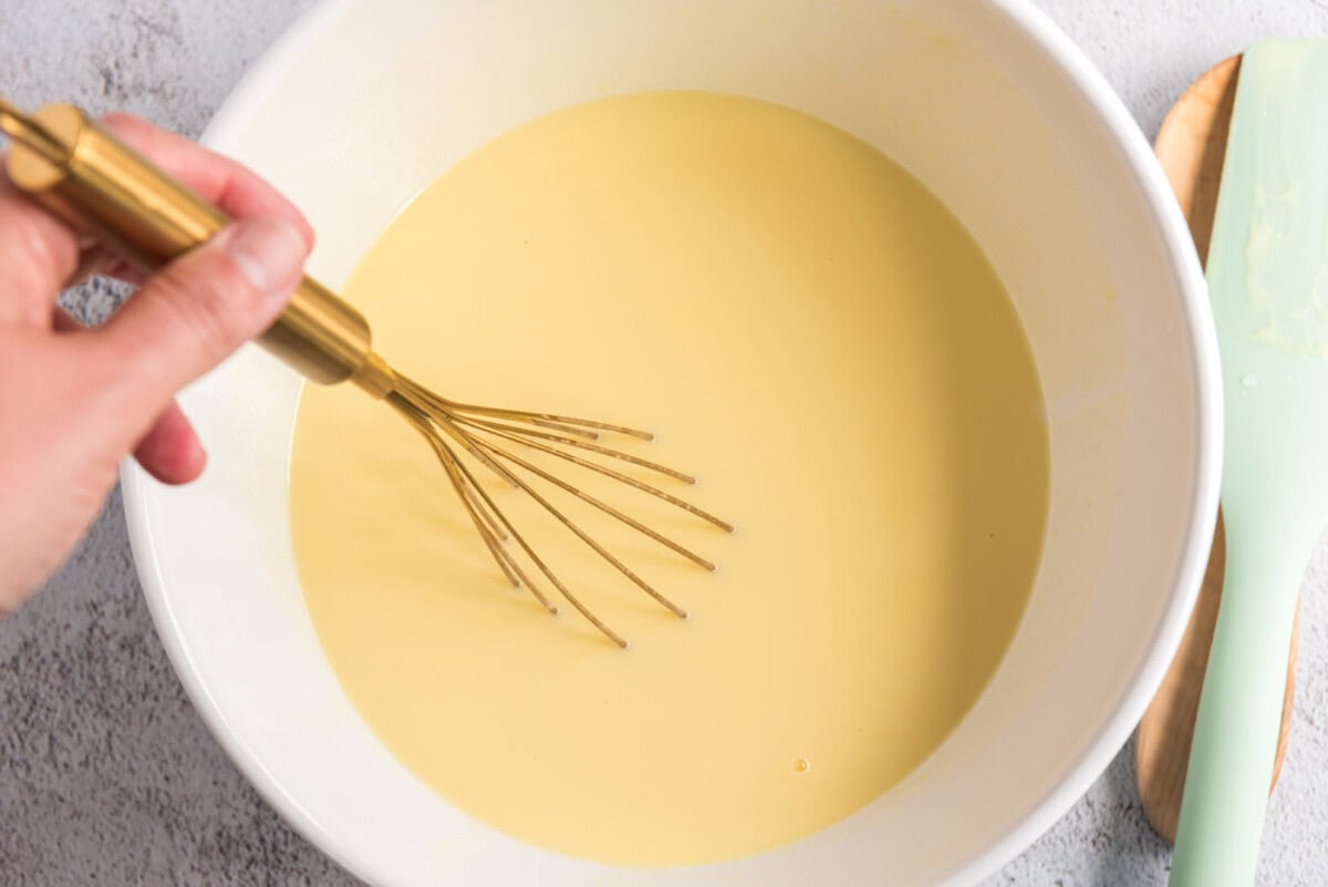 Custard mixture being stirred over an ice bath