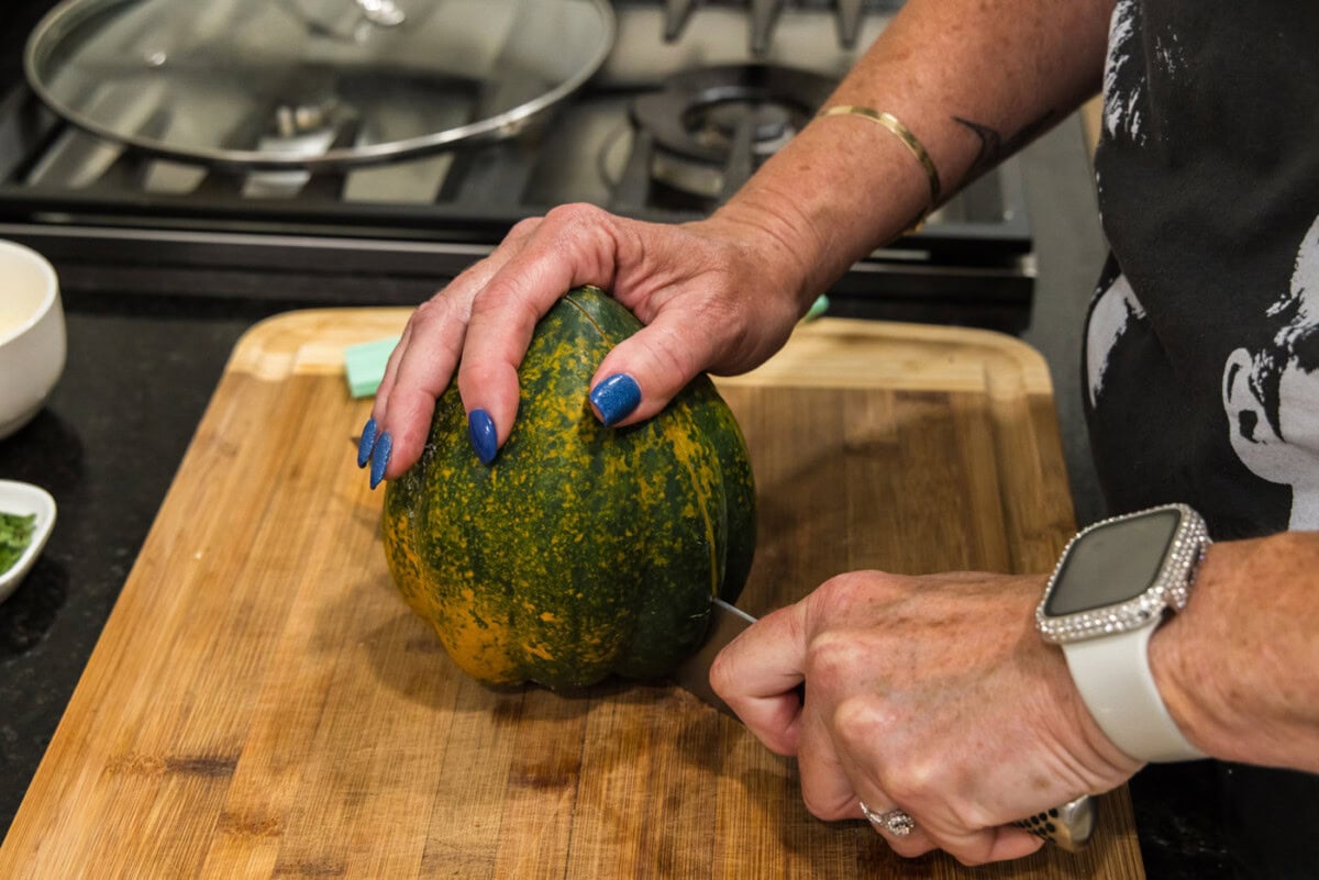 slicing an acorn squash in half