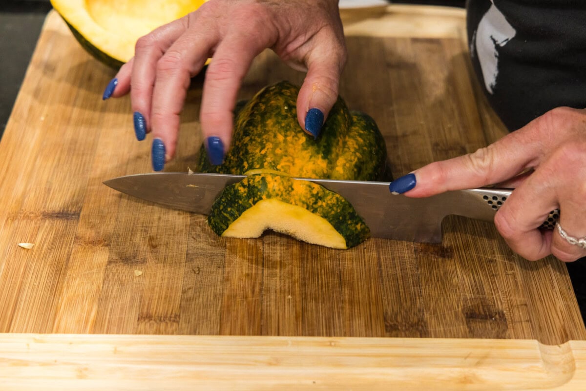 slicing acorn squash into half moon shapes