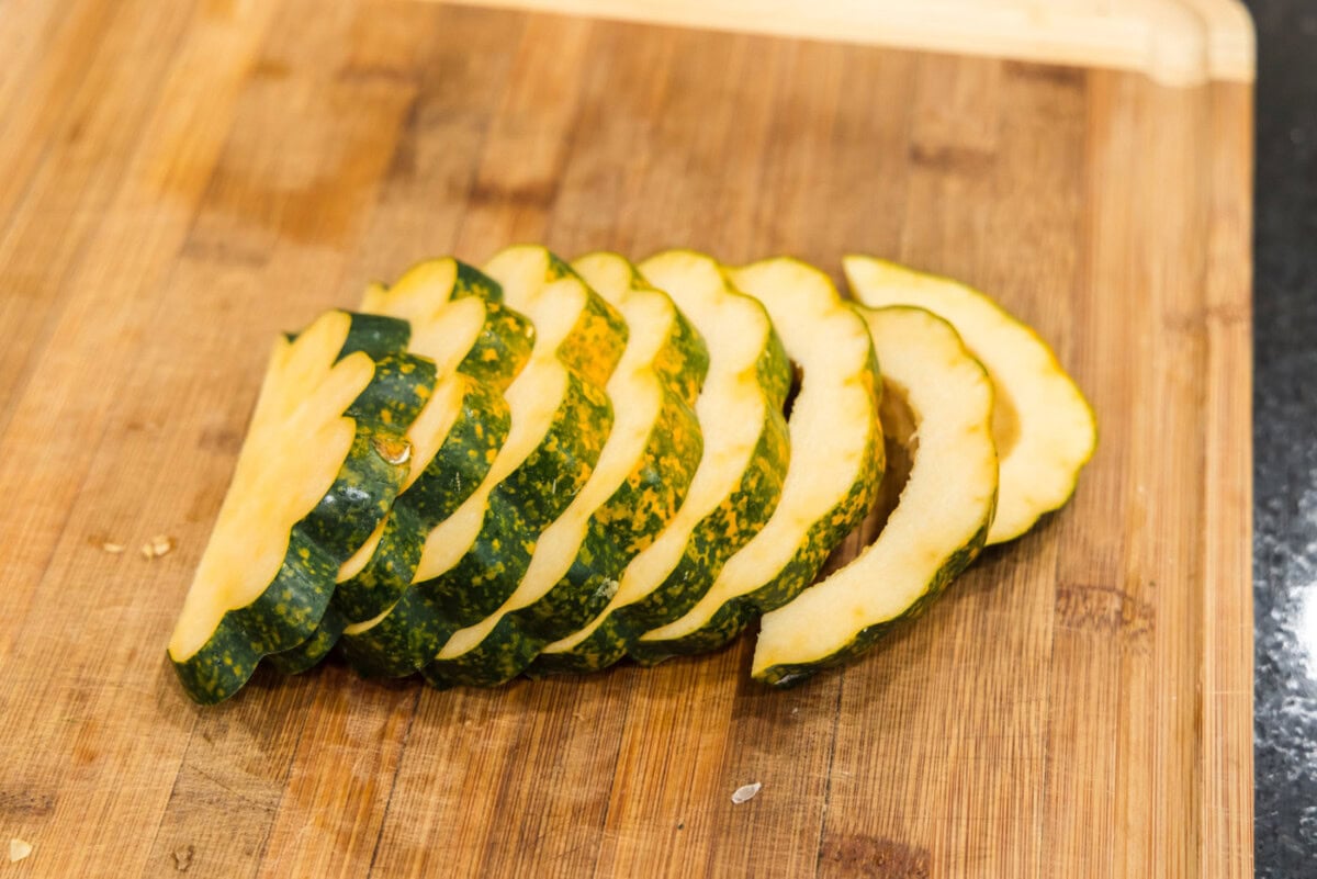 sliced acorn squash on a cutting board