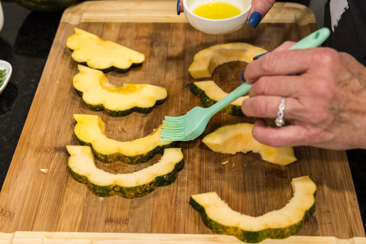 basting acorn squash slices with oil