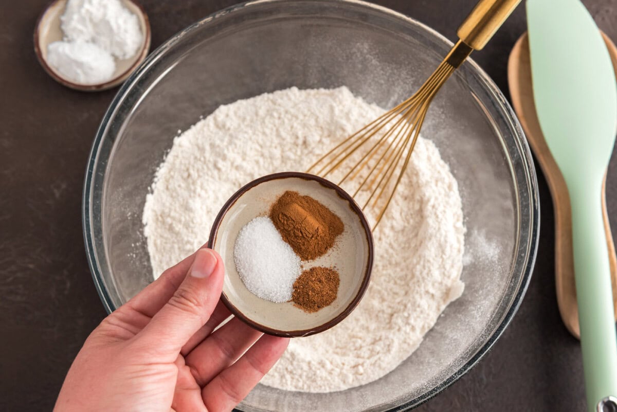 adding spices to flour in a bowl