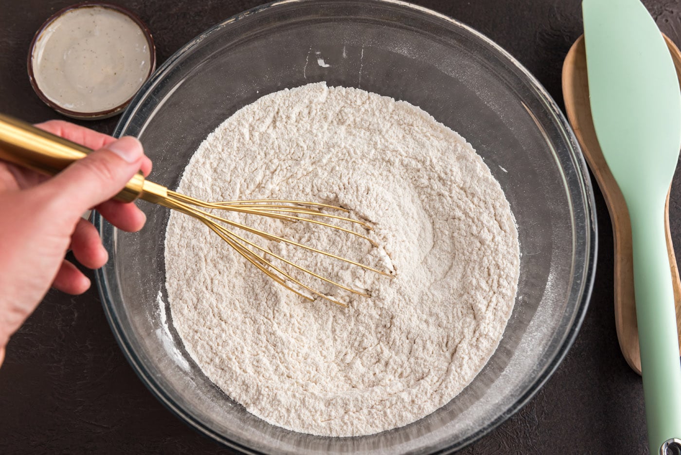 whisking flour, cinnamon, and nutmeg in a bowl