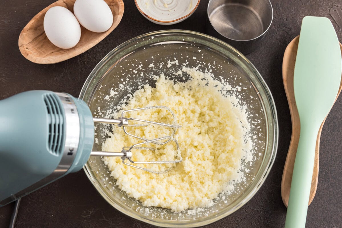 mixer beting butter in a bowl