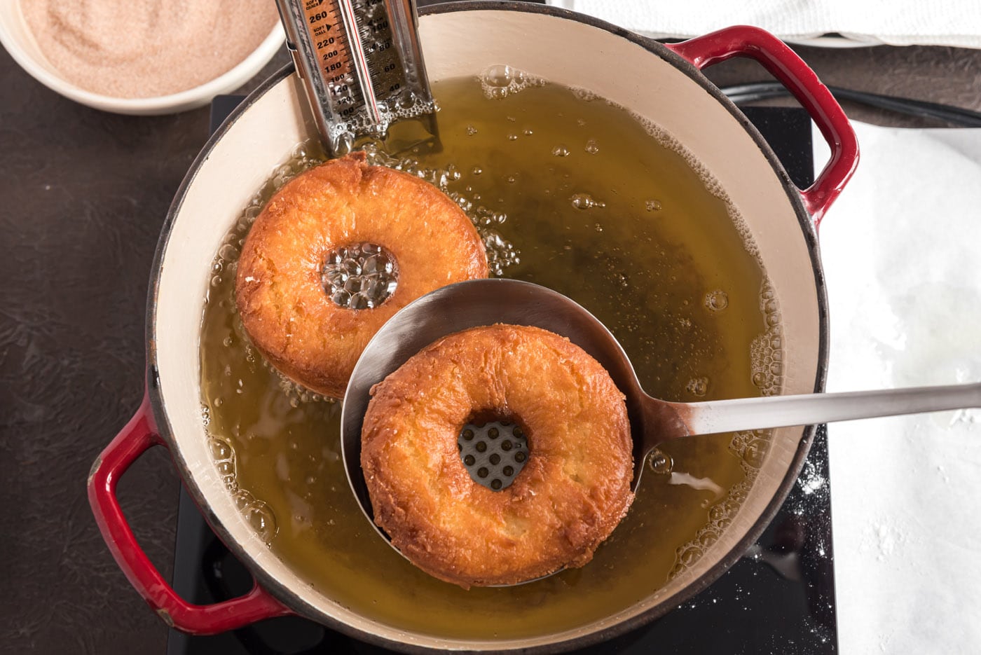 fried donuts being lifted from oil