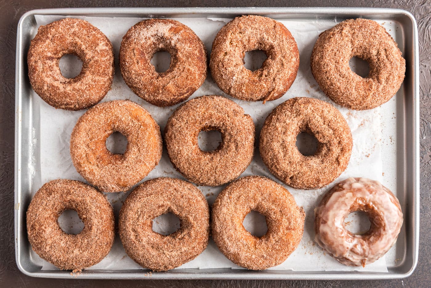 cinnamn sugar coated donuts on a baking sheet