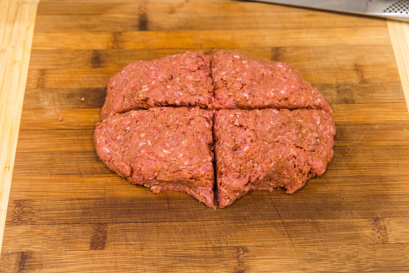 slicing burger patty into 4 triangles