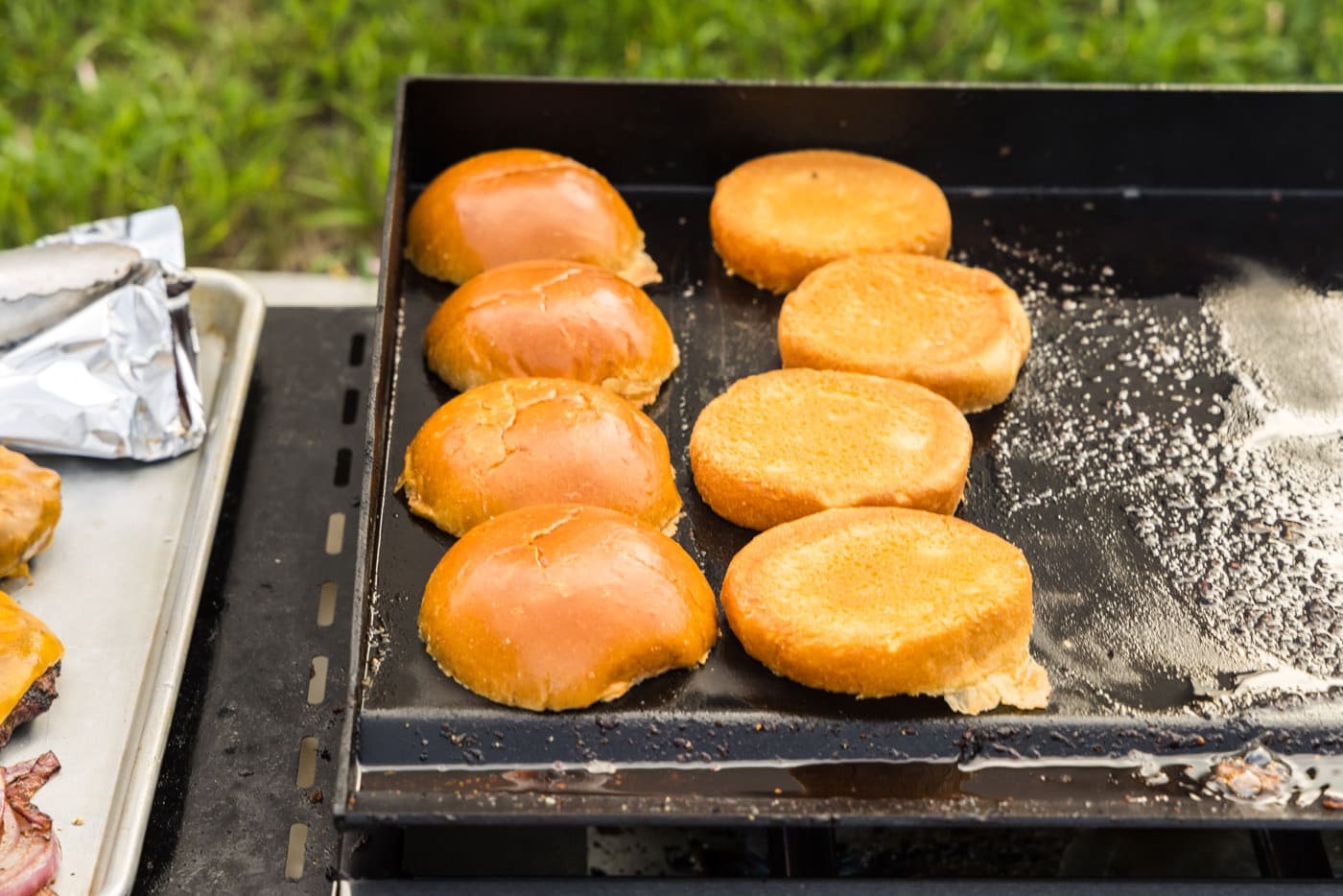 toasting burger buns on a grill