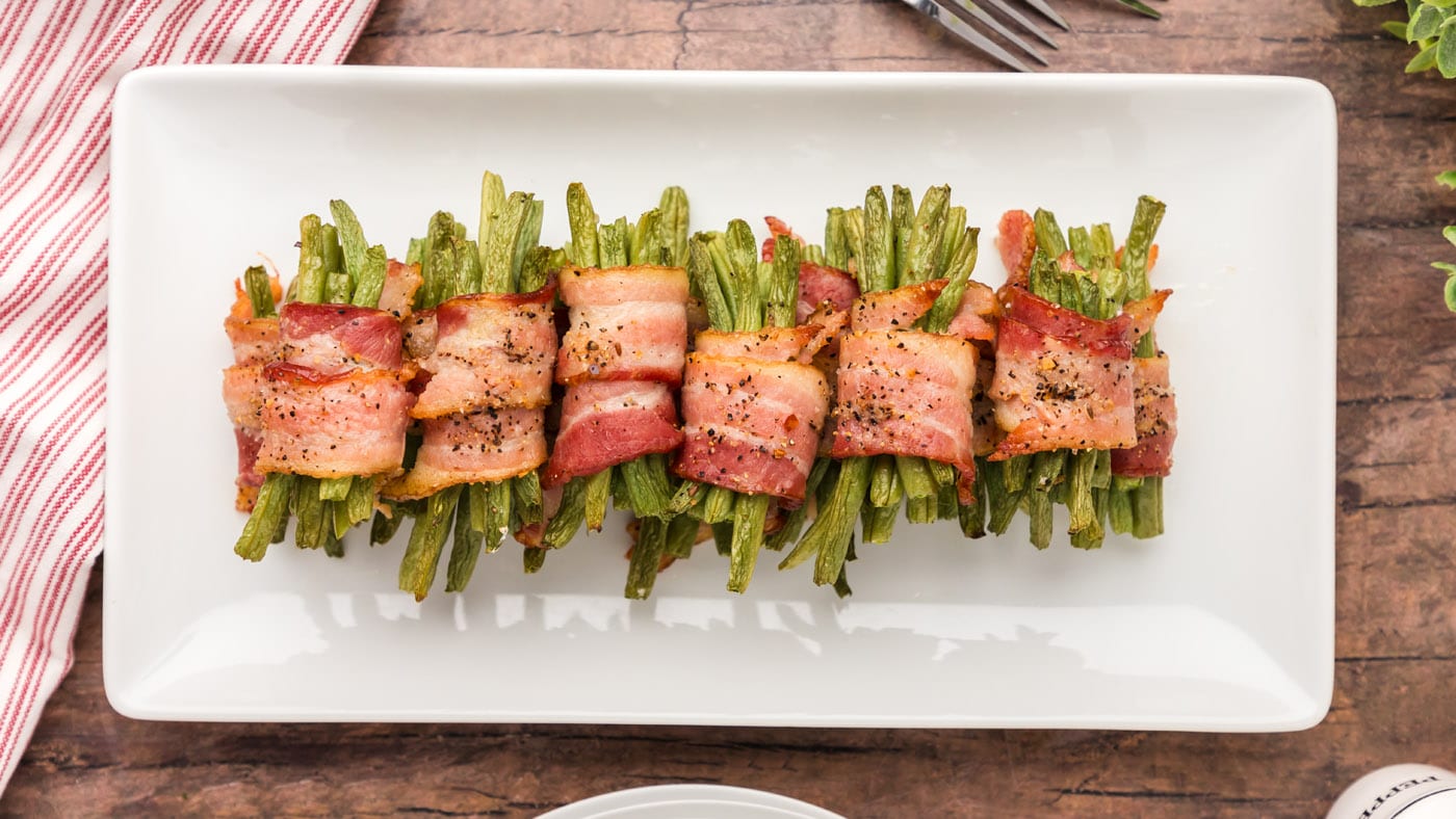 These bacon wrapped green beans are the star of every dinner plate. Simply secure a small bunch of g