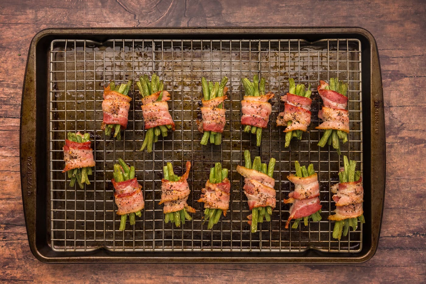 overhead finished shot of baked bacon wrapped green beans