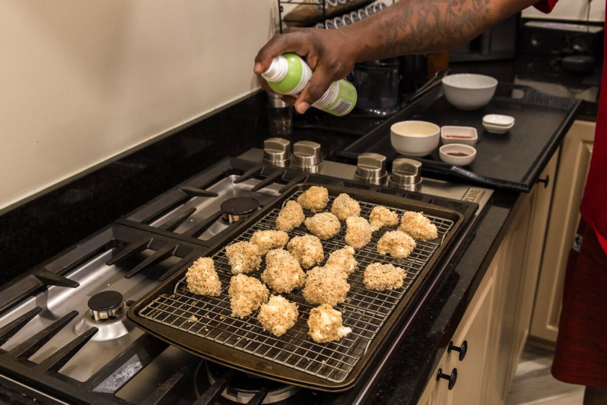 spraying bang bang cauliflower with olive oil spray