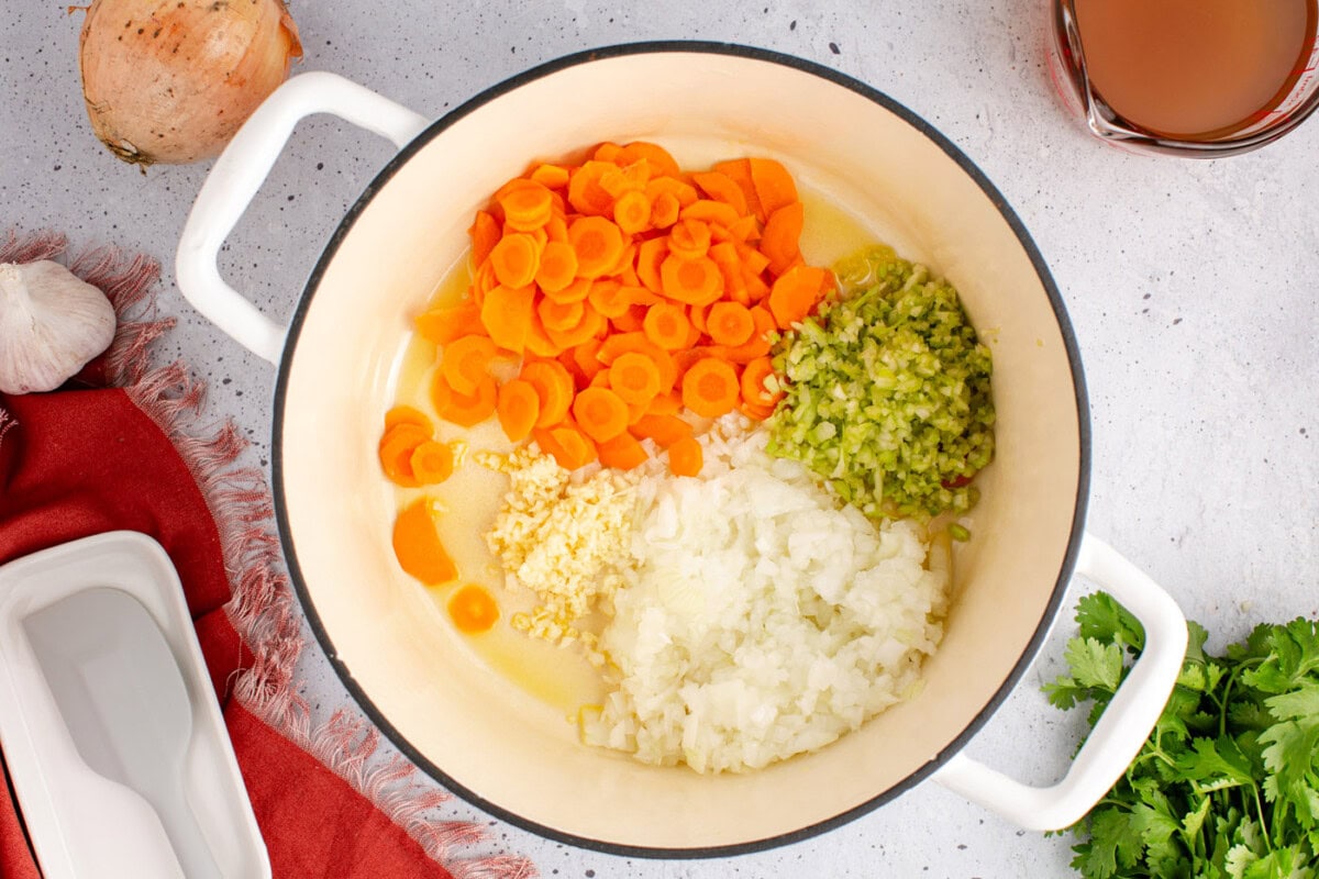 onion, carrots, celery, and garlic in a soup pot with oil