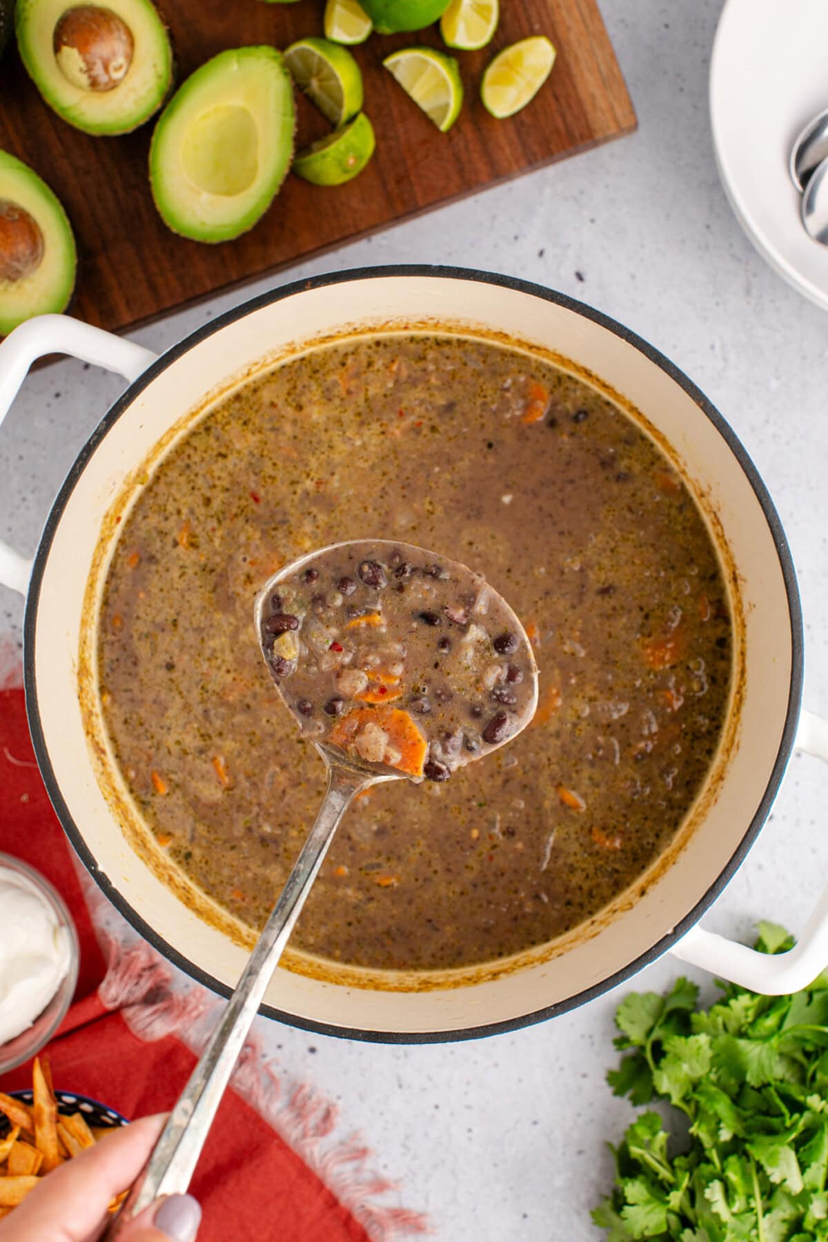 Ladle of Black Bean Soup held above a pot of Black Bean Soup