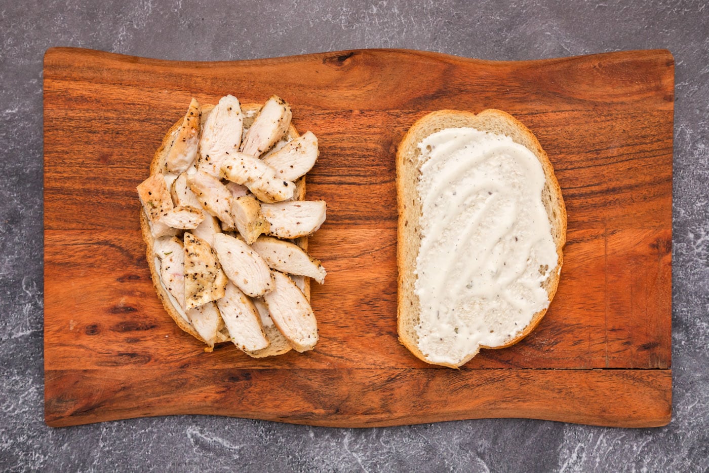 sliced chicken breast on top of ranch and rye bread