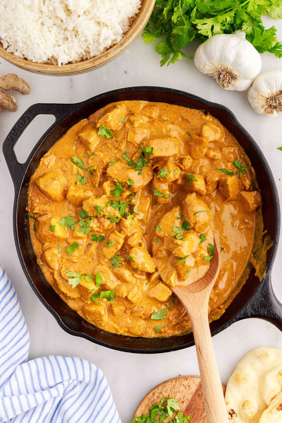 Skillet of Chicken Curry with a spoon in it
