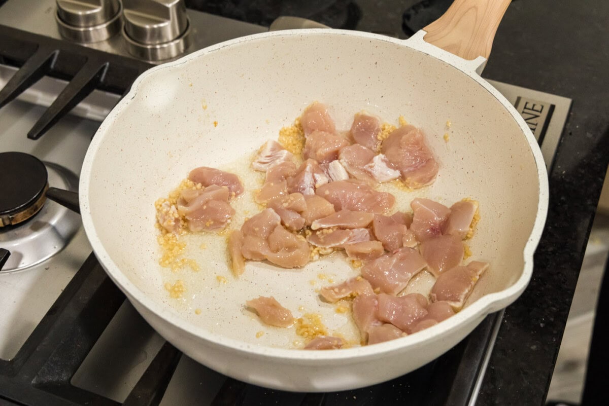 chicken in skillet with oil