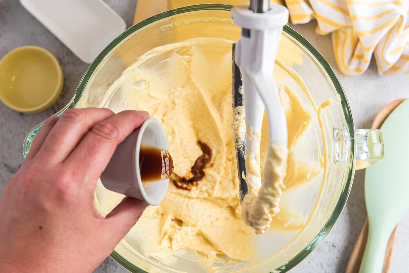 pouring vanilla into butter and sugar mixture
