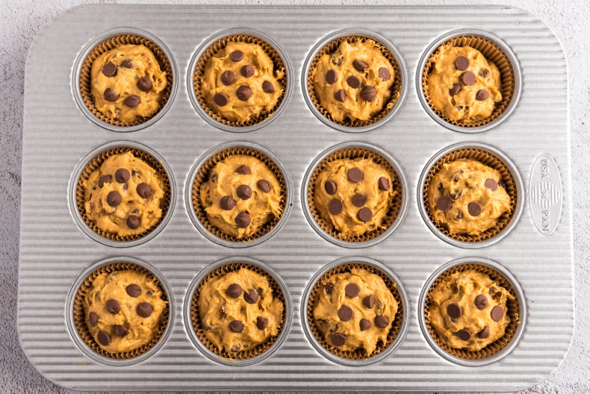 chocolate chip pumpkin muffin batter added to pan cavities