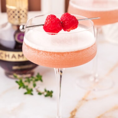 Close up photo of a French Martini garnished with raspberries