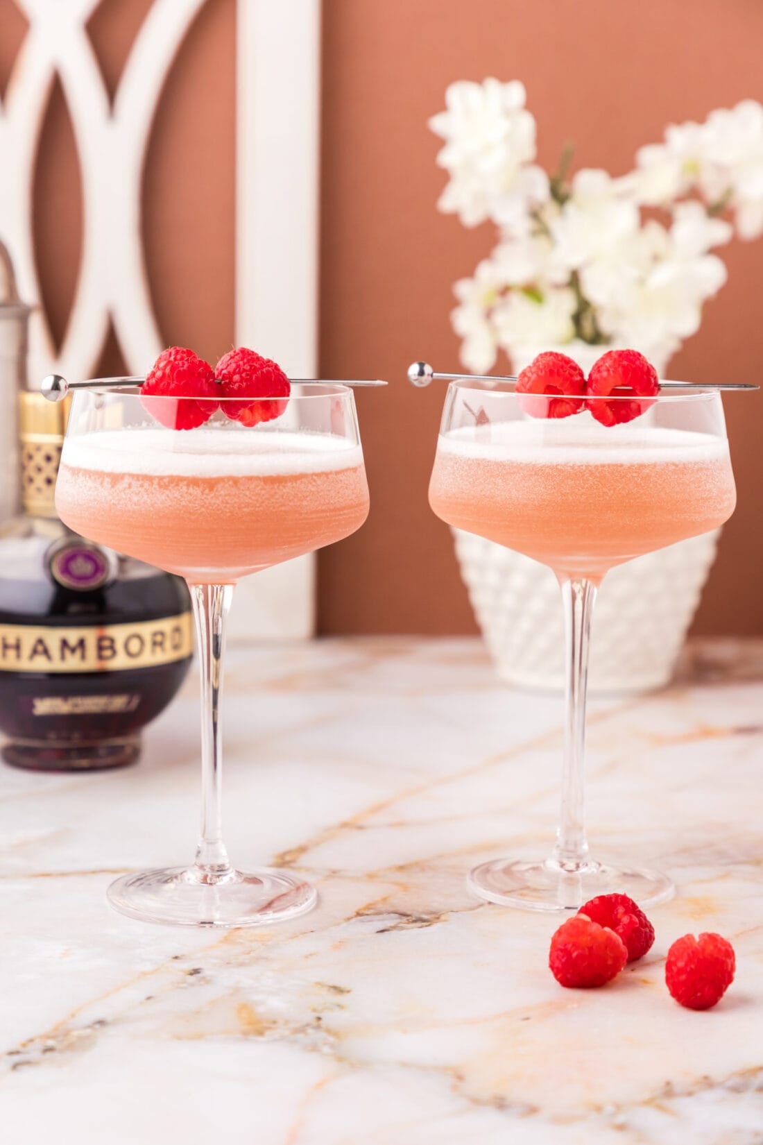 Two French Martinis topped with two raspberries 