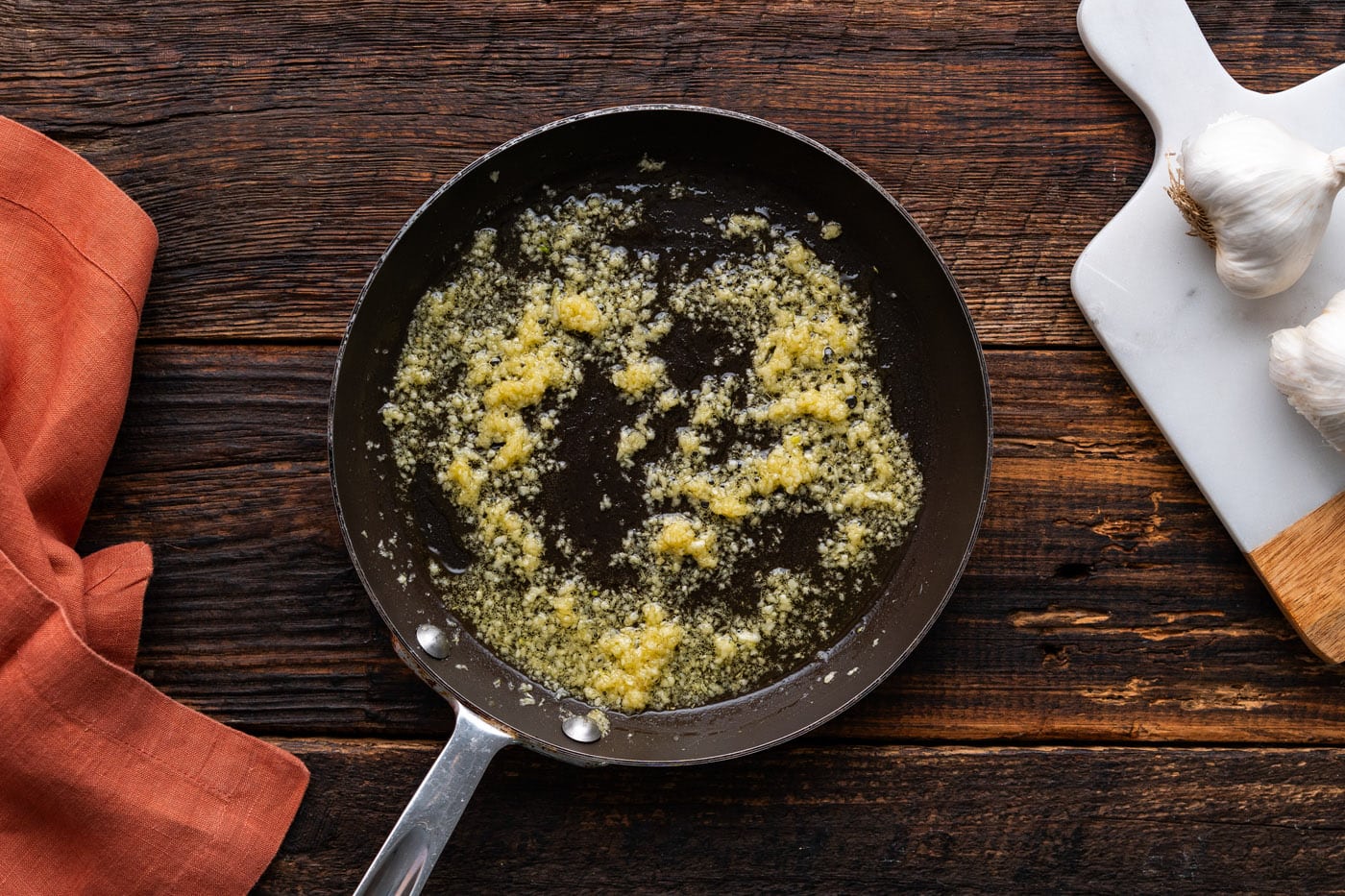 oil and minced garlic cooking in a skillet