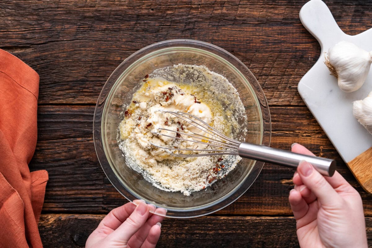 mixing parmesan garlic wing sauce ingredients in a bowl