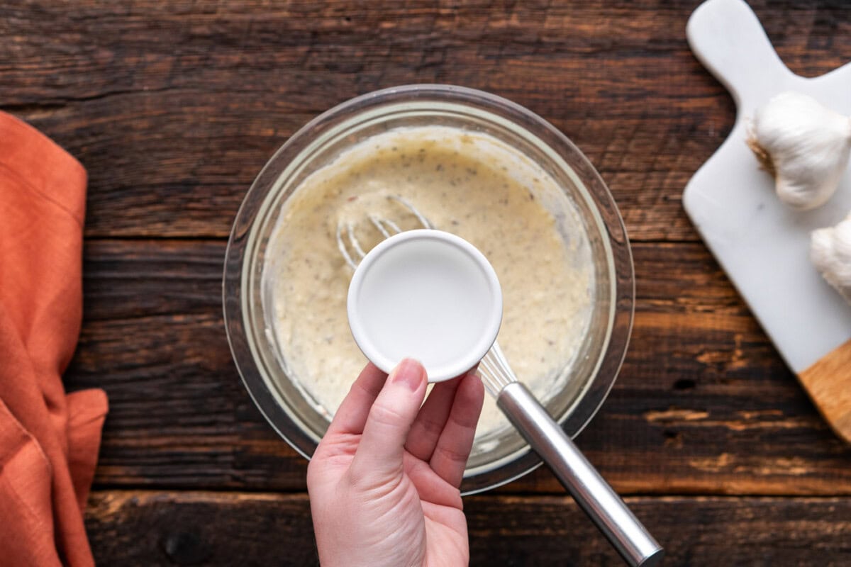 adding water to bowl of wing sauce