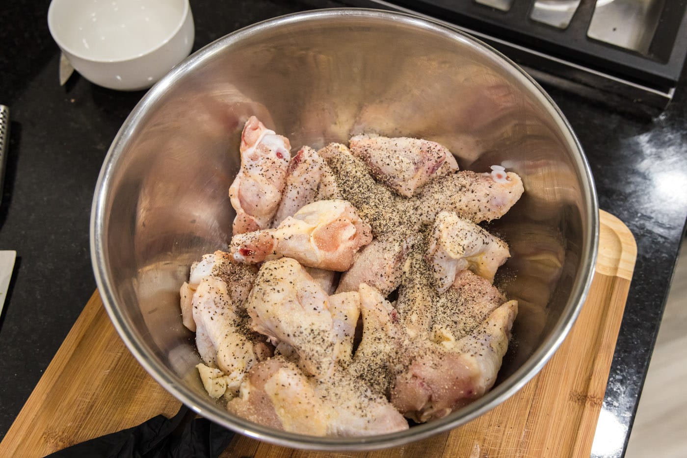chicken wings with garlic salt and pepper in a bowl