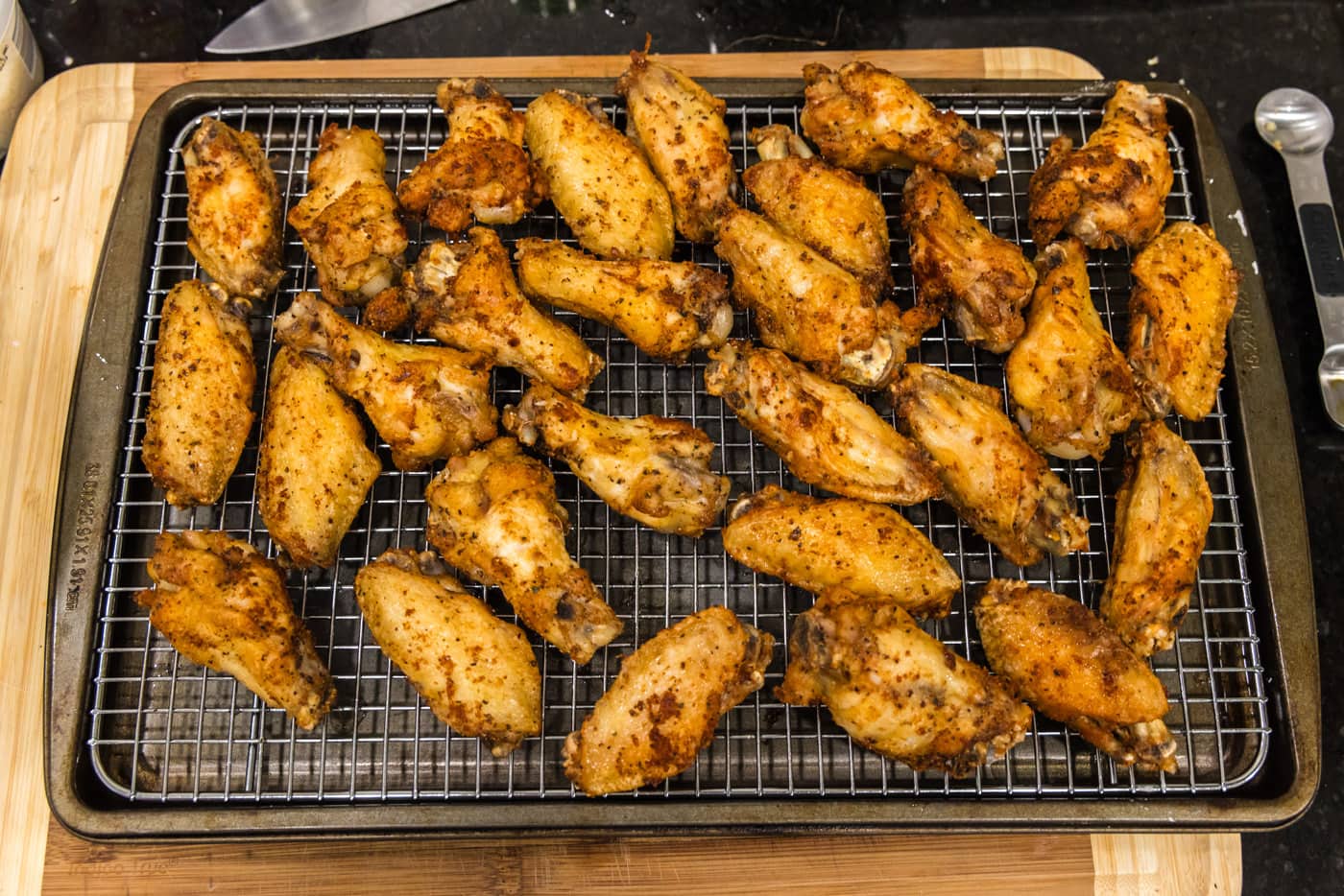 crispy fried chicken wings on a cooling rack