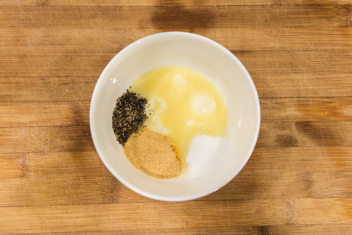butter, garlic powder, salt, and pepper in a bowl