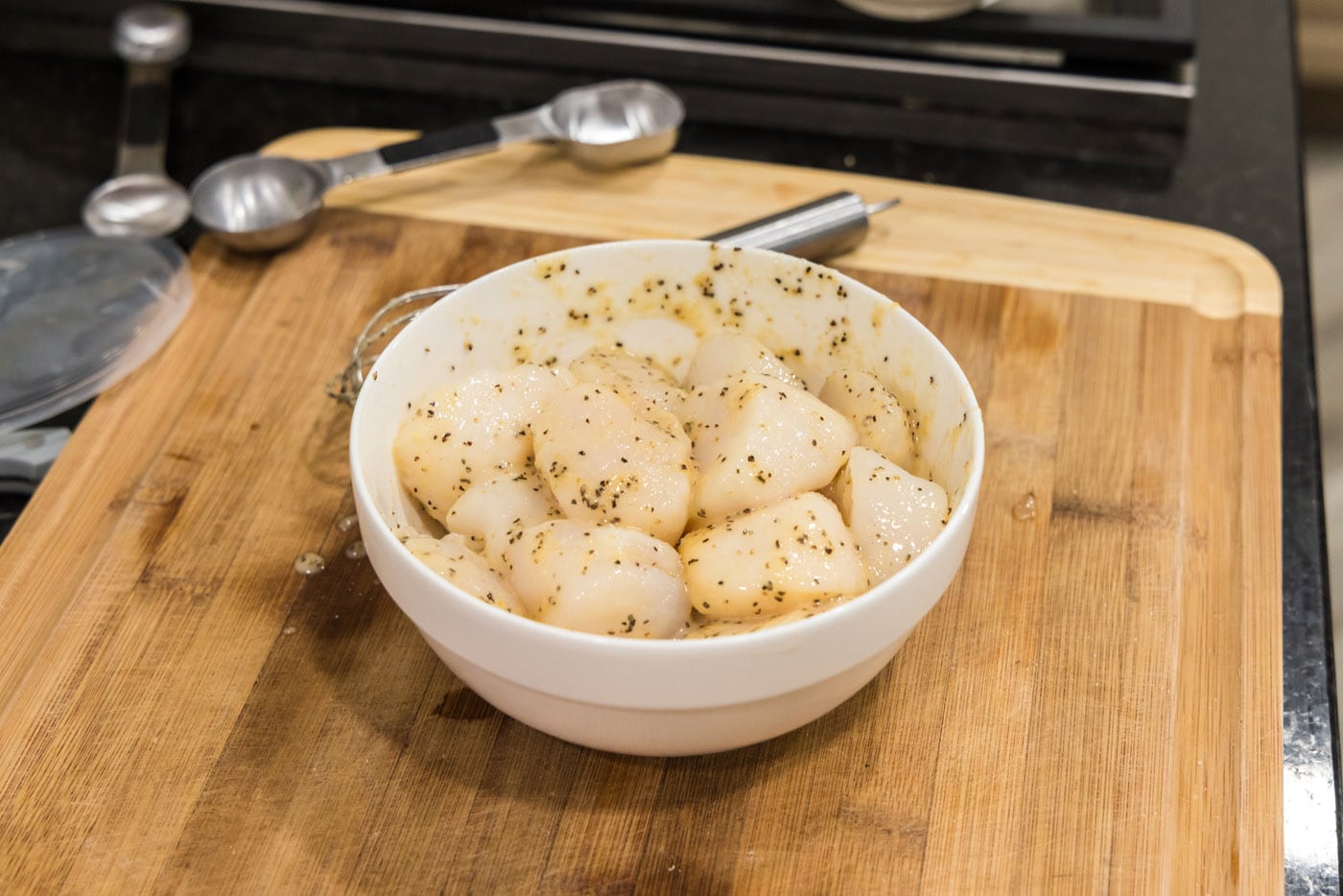 scallops in a bowl with butter mixture