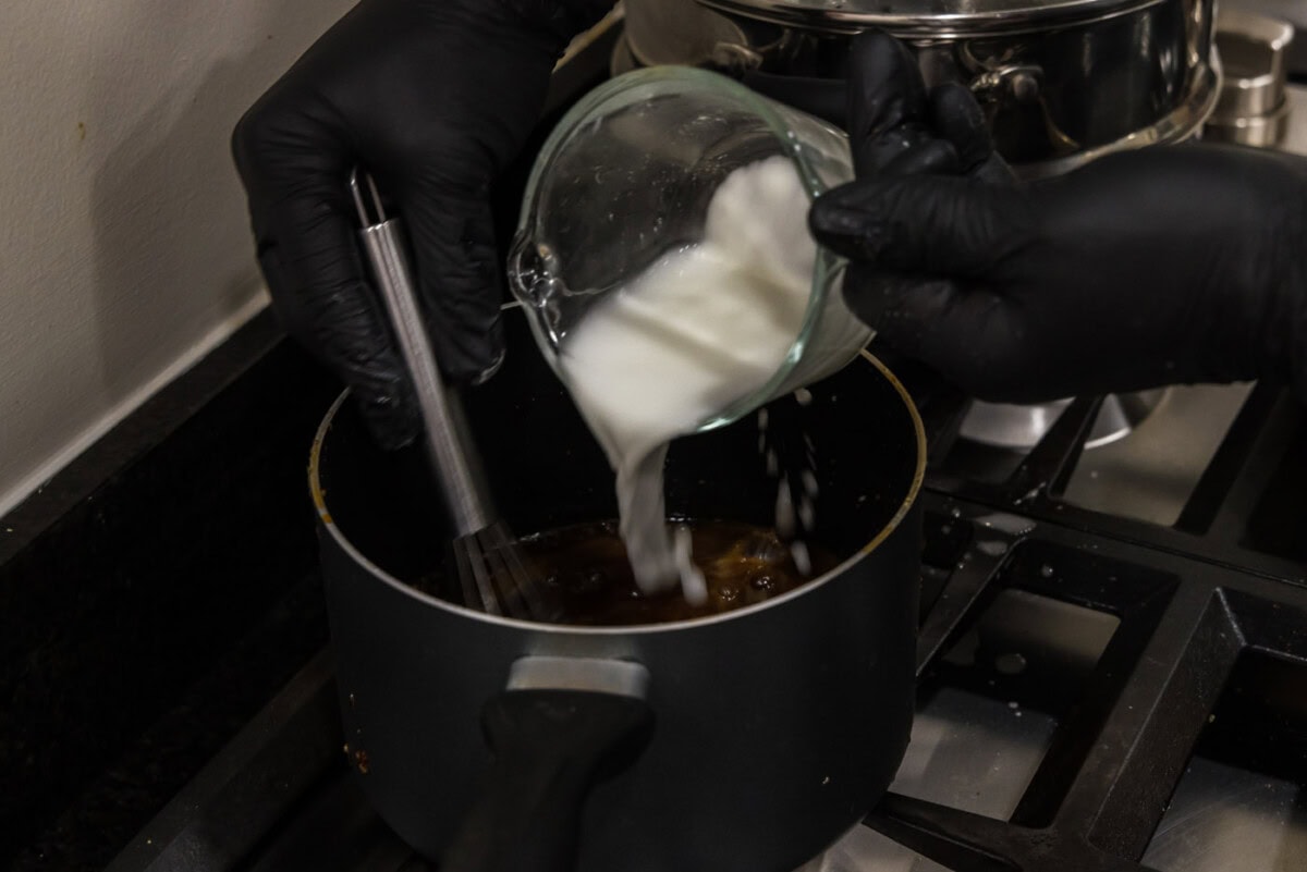 pouring cornstarch slurry into honey glaze for salmon