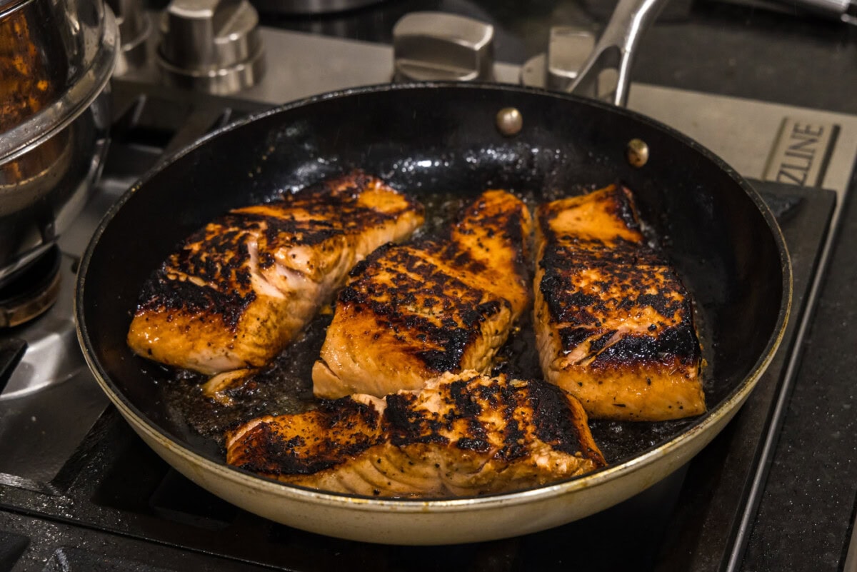 seared salmon filets in a skillet