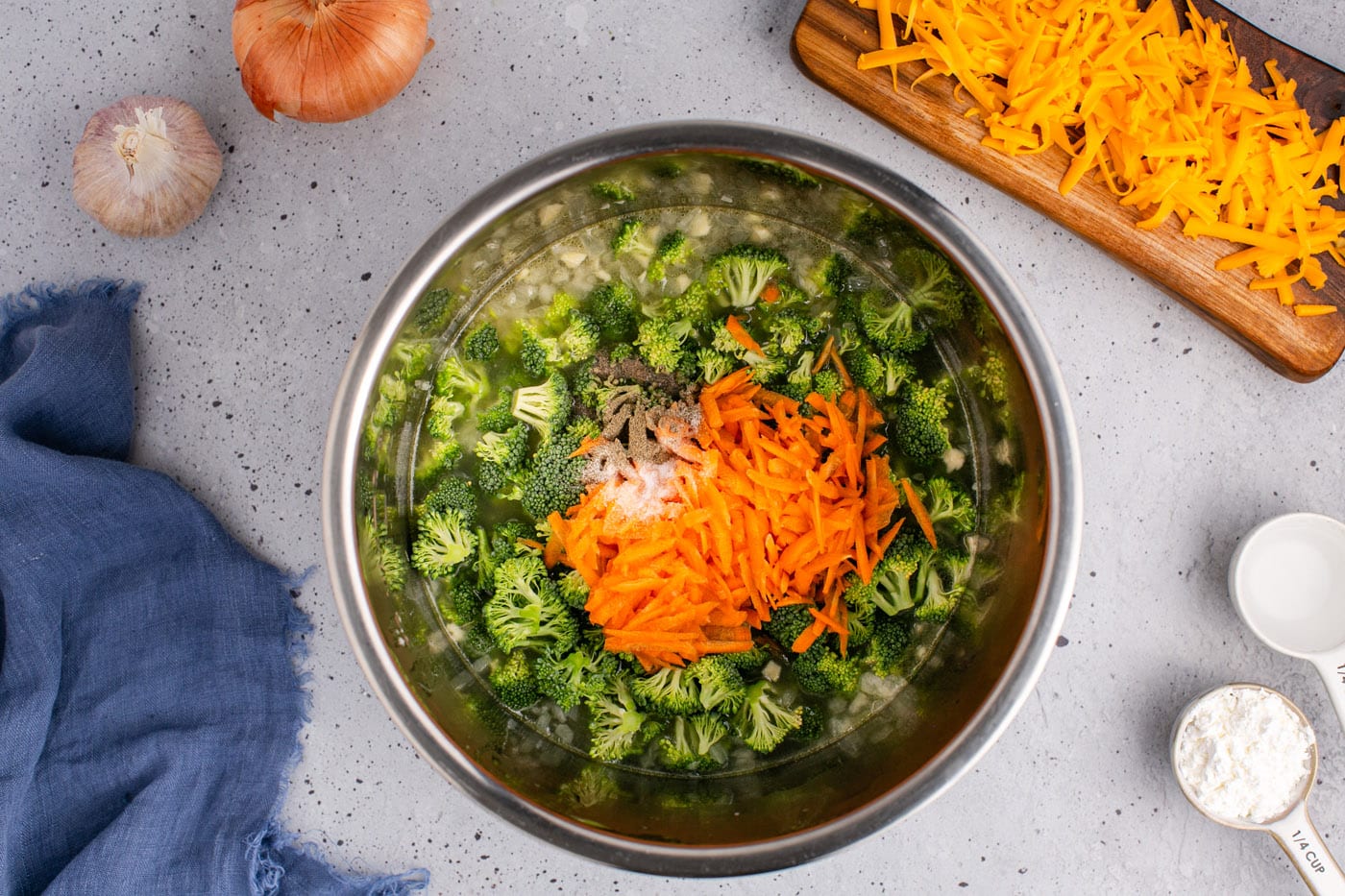 broccoli, shredded carrots, and seasonings added to butter mixture in an instant pot