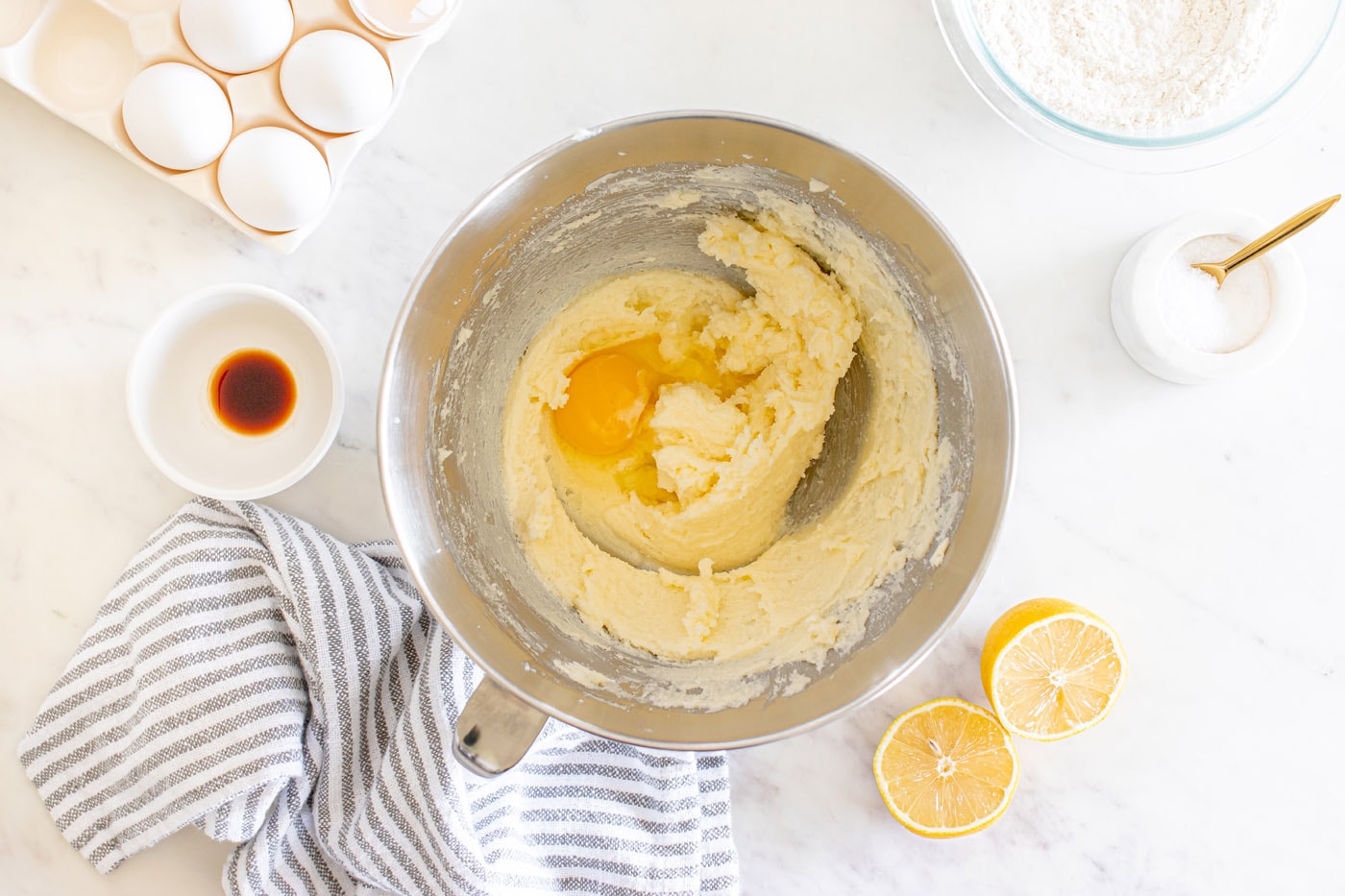 adding eggs to beaten butter and sugar mixture in a stand mixer