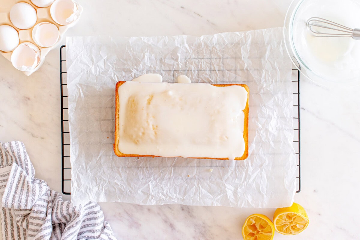 iced lemon pound cake on parchment paper