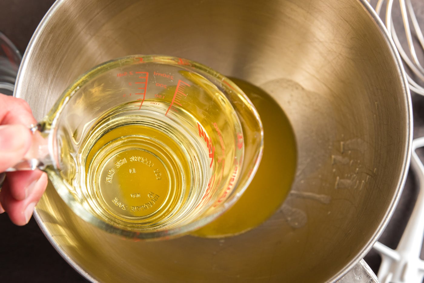 adding canola oil to melted butter in a bowl