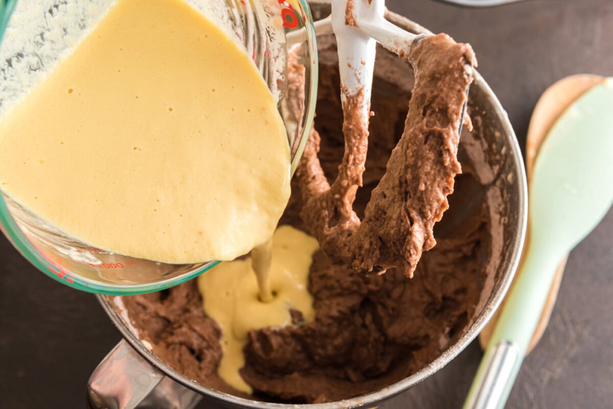pouring wet ingredients into chocolate mixture