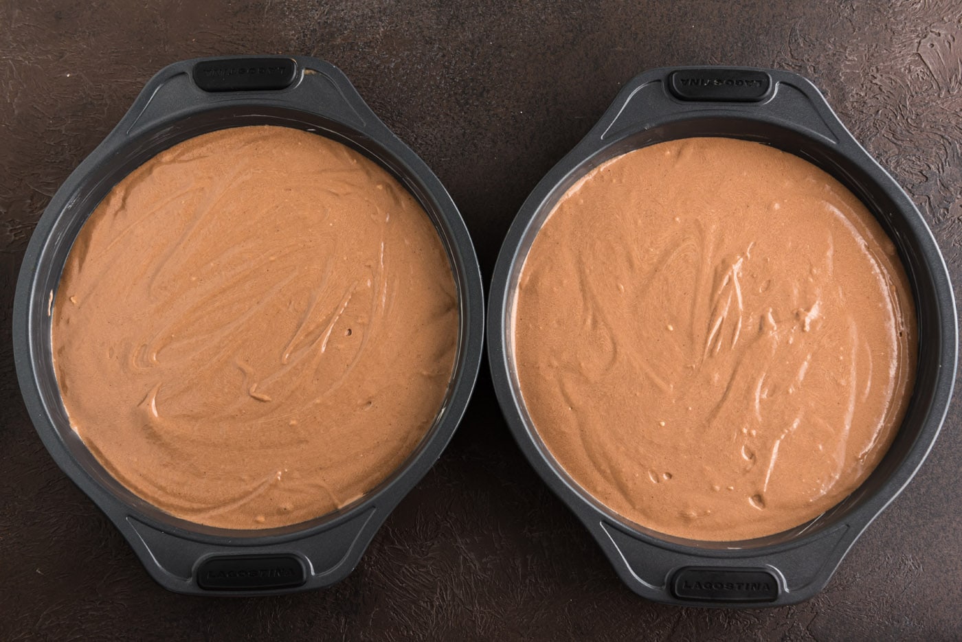 chocolate fudge cake batter in cake pans