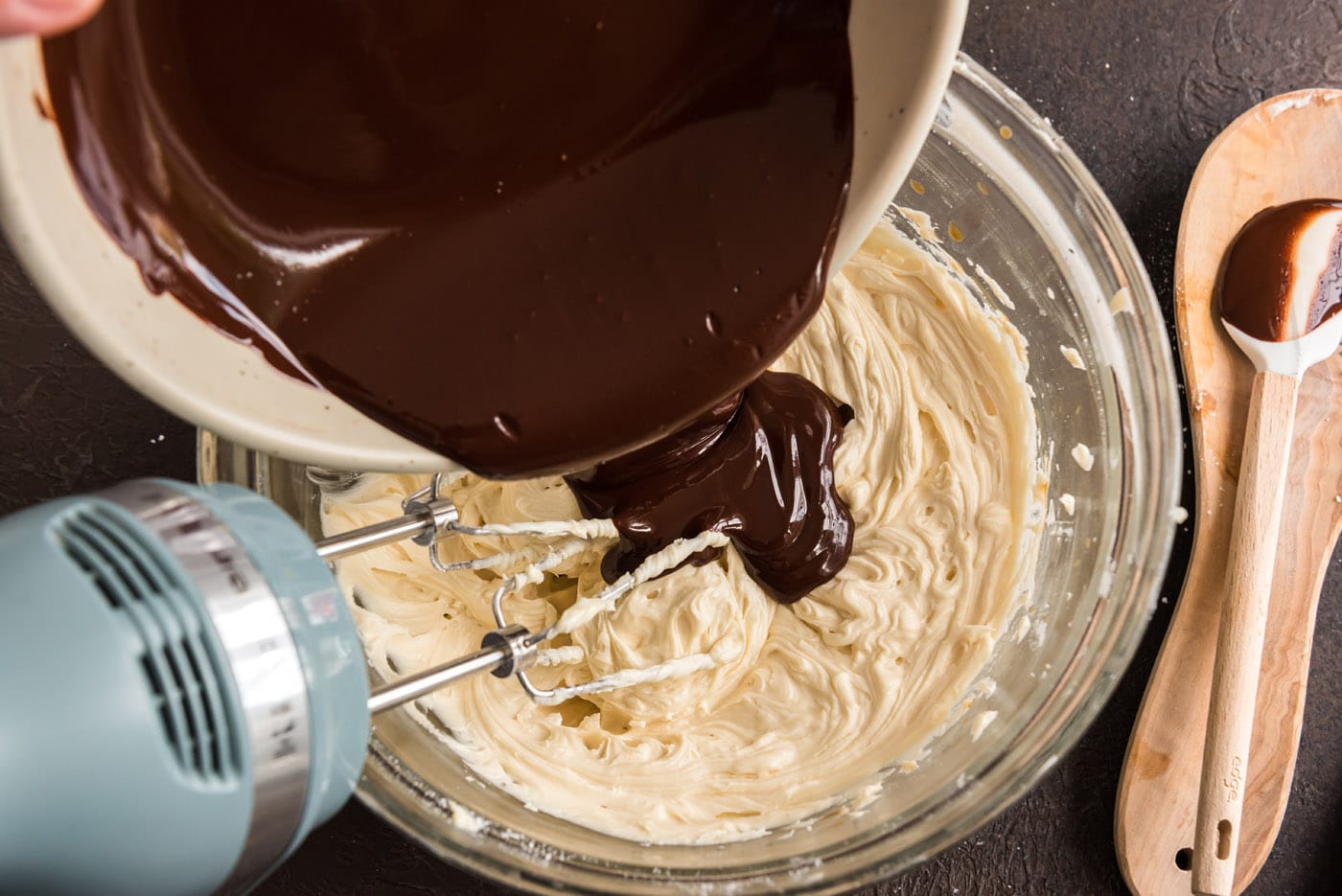 adding melted chocolate to frosting