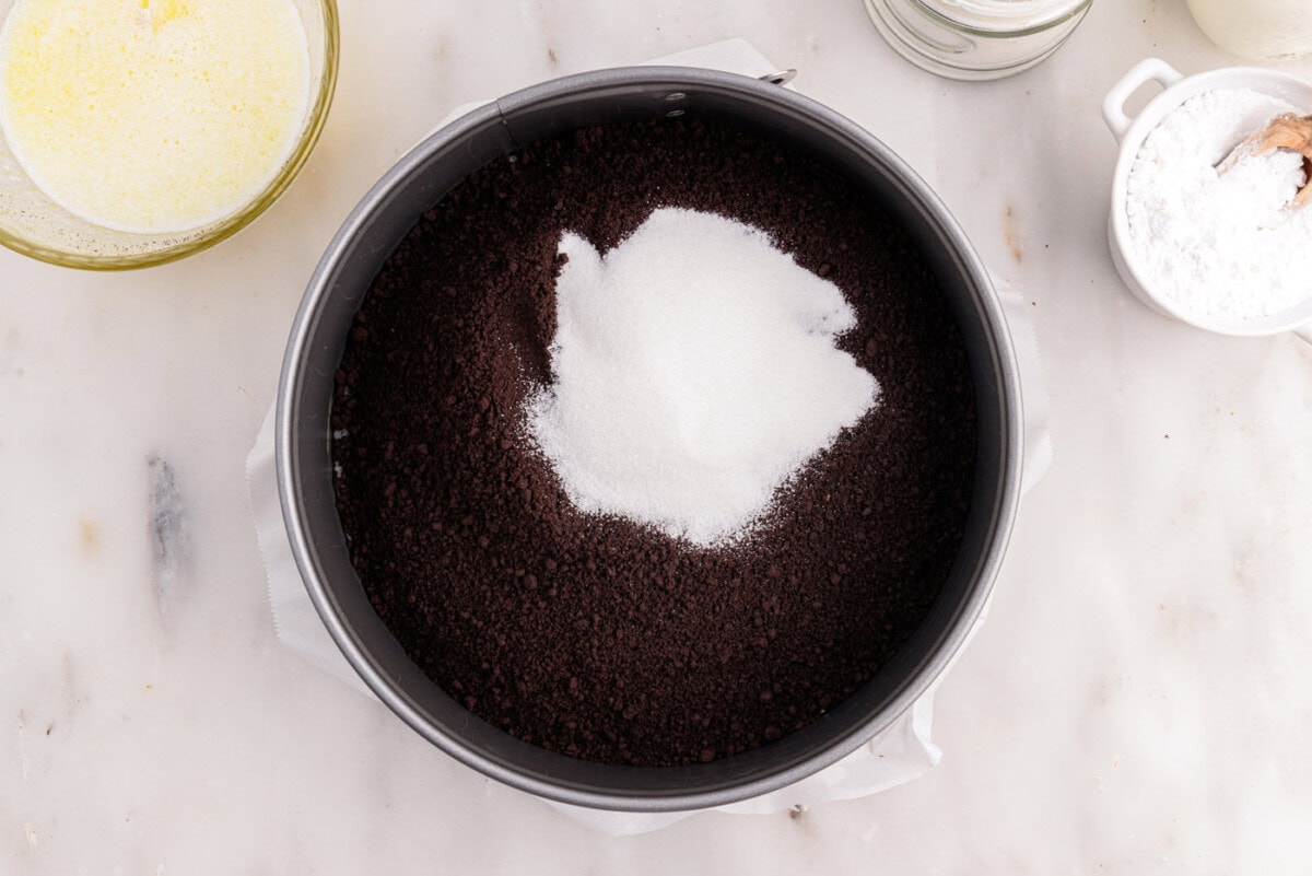 chocolate graham cracker crumbs and sugar in a springform pan