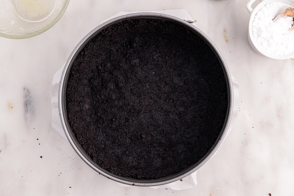 chocolate graham cracker crust for cheesecake in a springform pan
