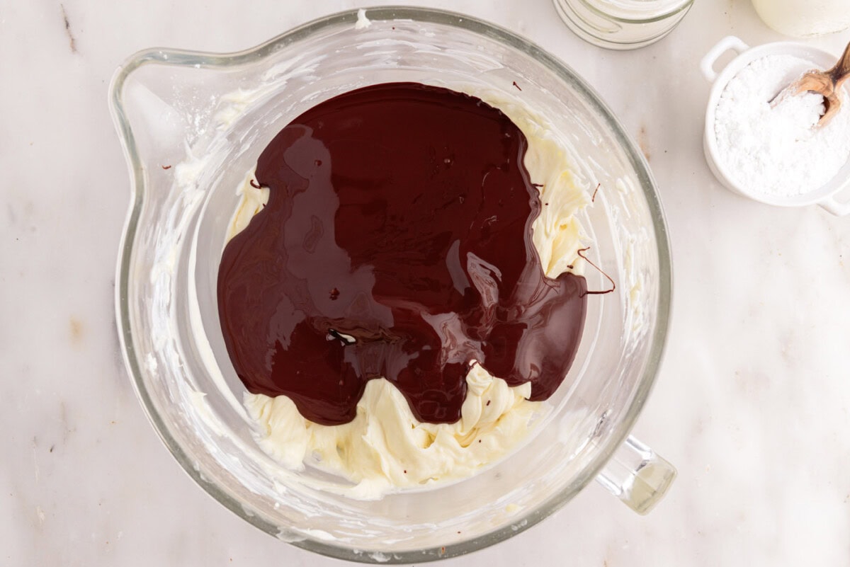melted chocolate added to cheesecake mixture in a bowl