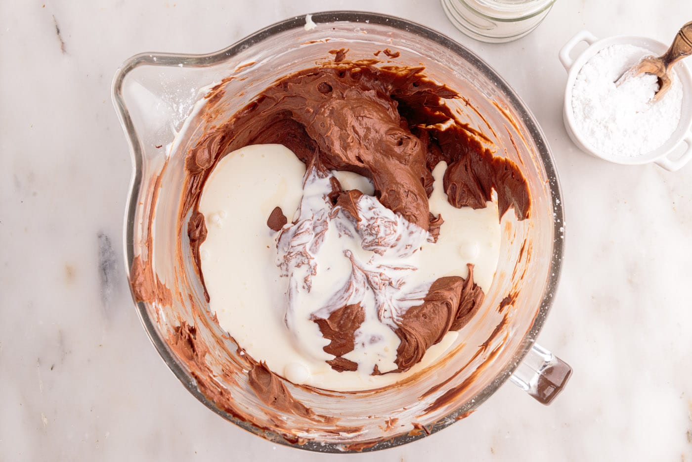 mixing heavy whipping cream to chocolate cheesecake mixture