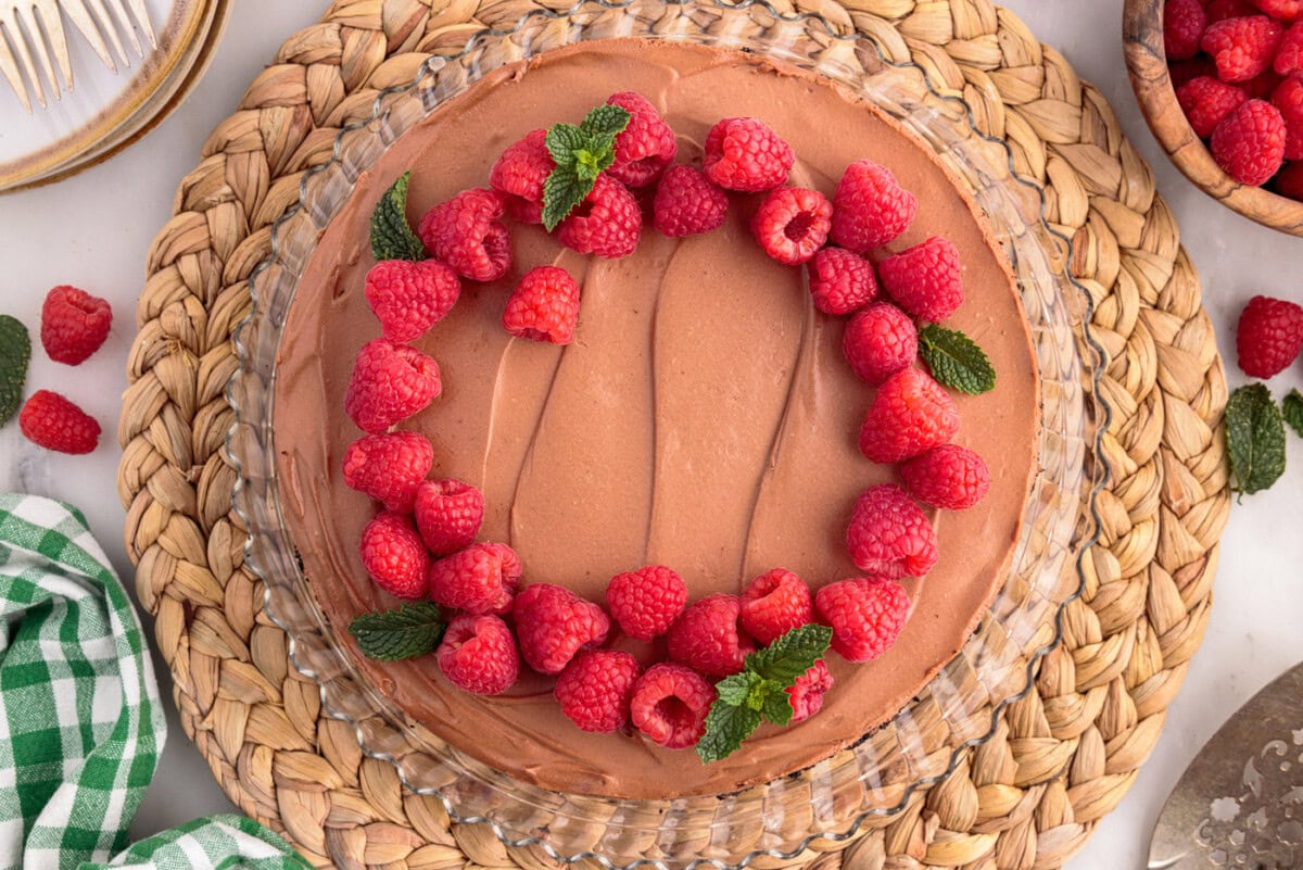 fresh raspberries and mint on top of no bake chocolate cheesecake