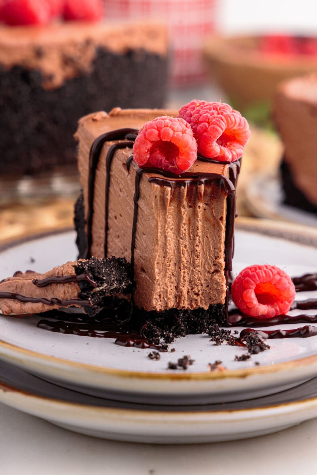 Slice of No Bake Chocolate Cheesecake on a plate with a bite taken out using a fork