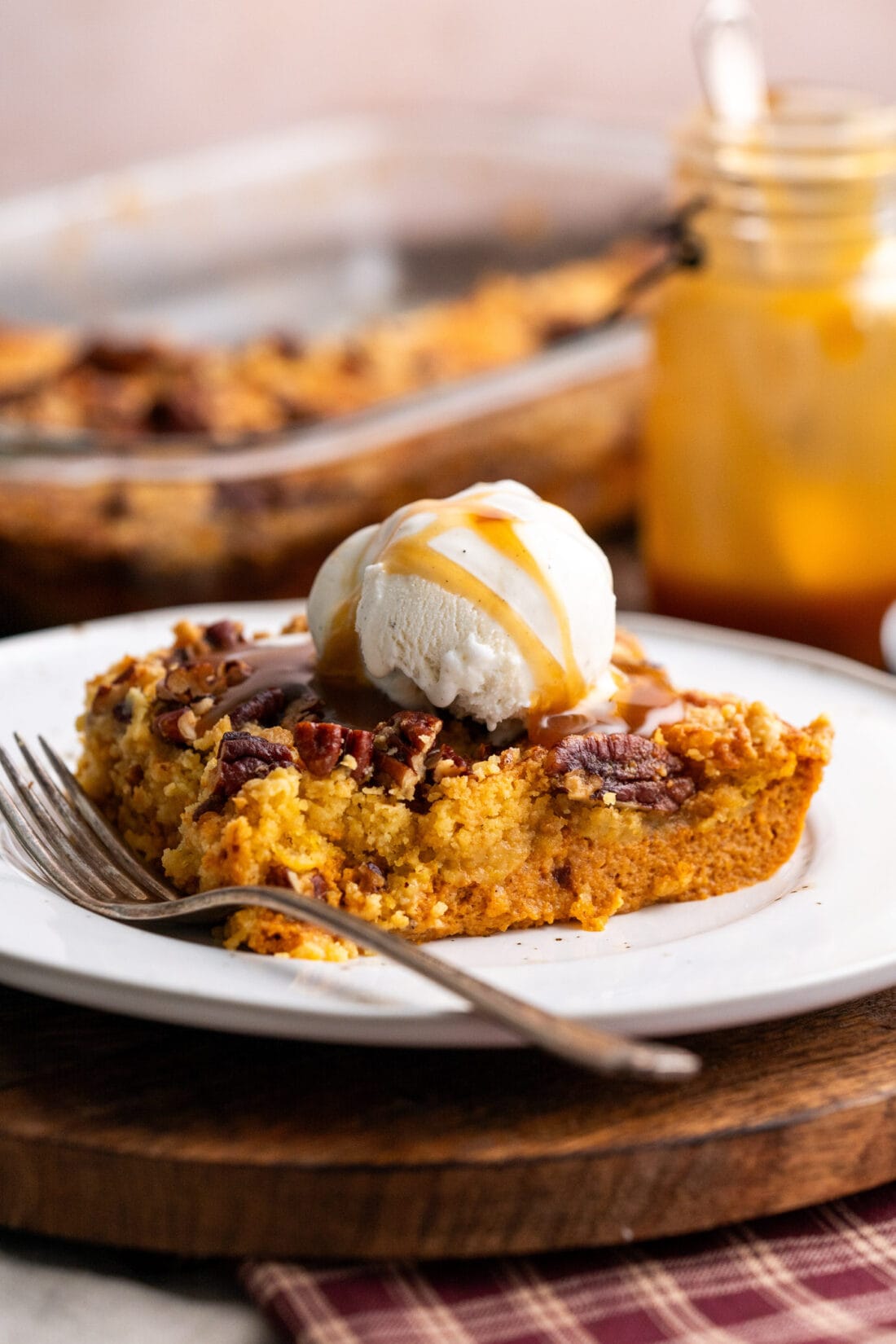 Piece of Pumpkin Dump Cake on a plate with a fork