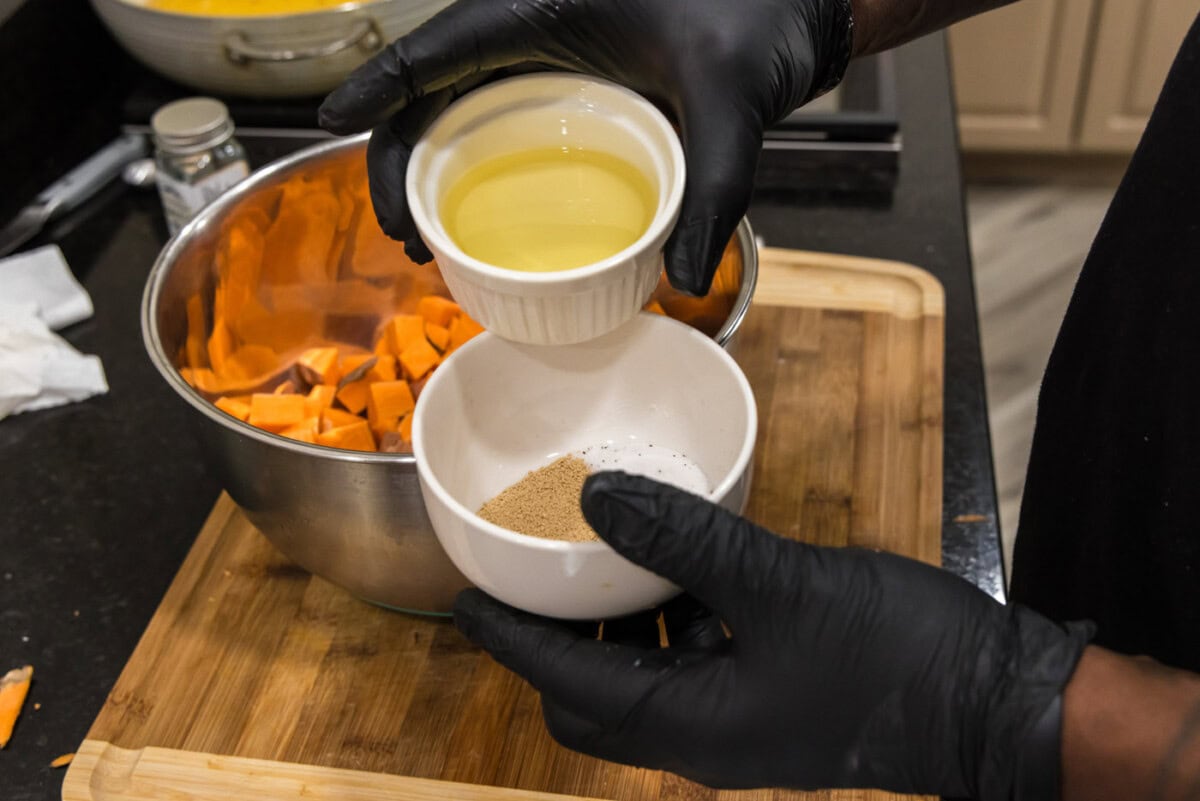 adding olive oil to seasonings in a bowl
