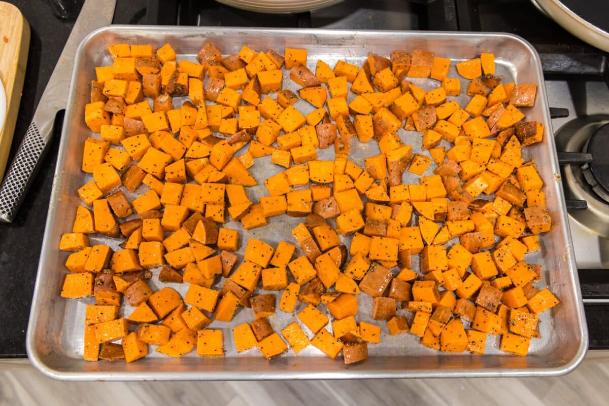 cubed sweet potatoes on a baking sheet